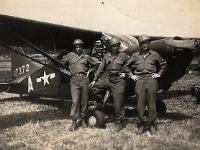 "Me and buddies and a little piper cub airplane, nice little plane" [Courtesy of Cpl Howard Skaggs, Co. A, 634th TD Bn.]