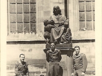 Cpl Leonard W. Hansman, on right, with unidentified buddies. [Photo courtesy of Brenda Daas, niece of L. W. Hansman]  Note: The statue is a monument to the priest and writer Christoph von Schmid (1768-1854) outside St. George's Church, Dinkelsbühl, Germany where the unit spent the postwar summer of 1945.