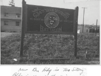 "Our Bn Hdq is two story Bldg in rear of the sign. First we will have to get started!"  - Photo courtesy of Jay Olson, son of Maj Errol B. Olson